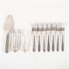 Plated Silver Dessert Flatware: A plated silver dessert service. The collection includes various makers of flatware including Sheffield and Holmes & Edwards. The set features a pie server, two pairs of tongs, and seven pastry forks.