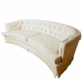 Vintage Sofa by Twin City Upholstery Company: A vintage sofa by Twin City Upholstery Company. This sofa features a curved button tufted back over a pair of removable seat cushions that rises above an apron skirt. The seat is marked “Twin City Upholstery Co.”