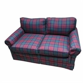 Plaid Upholstered Loveseat by Lane: A loveseat by Lane Upholstery, Inc. This American made piece is fully upholstered with plaid fabric in shades of red, blue and green, and it features armrest covers, two removable seat cushions and a dust skirt at the base.
