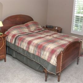 Antique Louis XVI Style Walnut Full Size Bed: An antique Louis XVI style walnut full size bed. This piece is constructed from walnut, and it includes a domed headboard, side rails and a curved footboard with pilasters over carved, turned feet. The bedding shown is included, but the mattress and box spring are not.