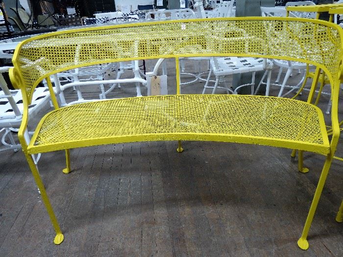 Antique garden bench restored in a textured sunshine yellow powder coated finish.