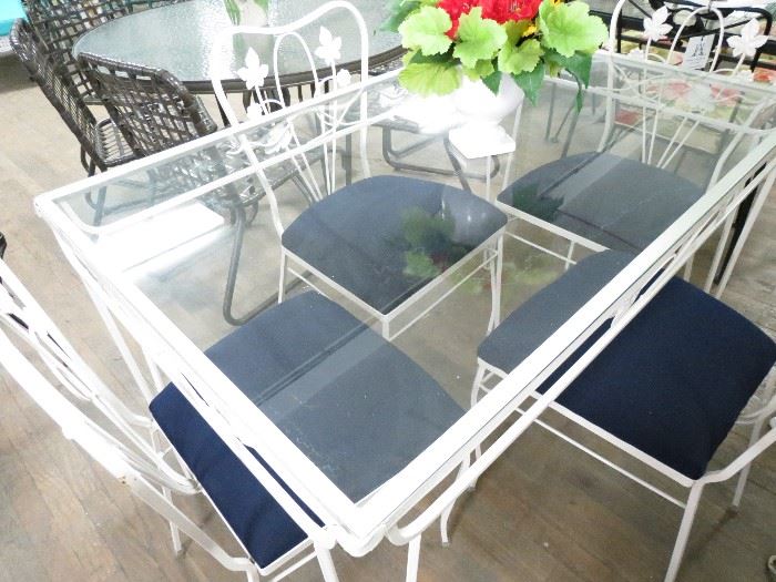 Salterini indoor/outdoor dining set in white powder coated finish includes glass top rectangular table with 4 chairs with new navy sunbrella fabric cushions.