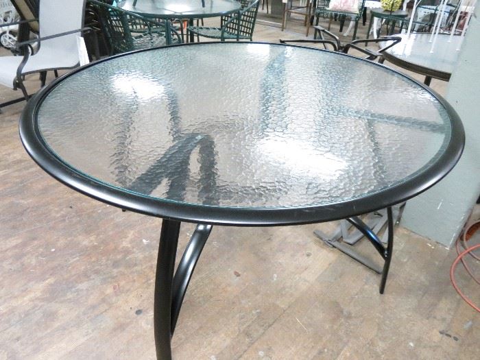 Brown Jordan aluminum dining table with glass. Powder coated in a satin black finish.  Excellent condition.