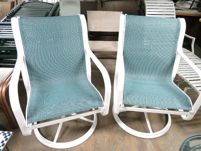 Vintage Brown Jordan swivel chairs of aluminum and new stone blue slings.