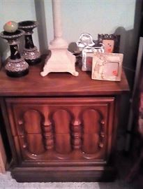 nightstand, lamp, candlesticks, picture frames