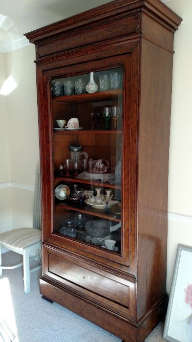 This china cabinet/display case breaks down in 3 easy to move pieces. It also has a hidden drawer in the foot molding under the obvious lower drawer. See next picture. This is a beautiful piece of older furniture