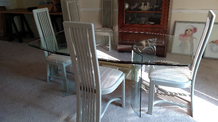 This is a large glass table with 6 chairs. The brass center piece would look really nice painted is a satin black