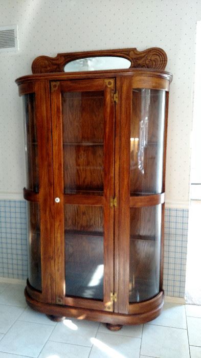 This oak case has glass shelves and is lighted