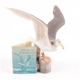 Scott Woolever Limited Edition Porcelain Sculpture of a Seagull: A limited edition porcelain sculpture of a seagull titled The Great Black-Backed Gull by artist, Scott Woolever. This hand painted sculpture depicts an imposing seagull preparing to take flight, with its wings expanded. The sculpture is marked to the underside. It is presented with an original tag that is inscribed with additional information on the Great Black-backed Gull.