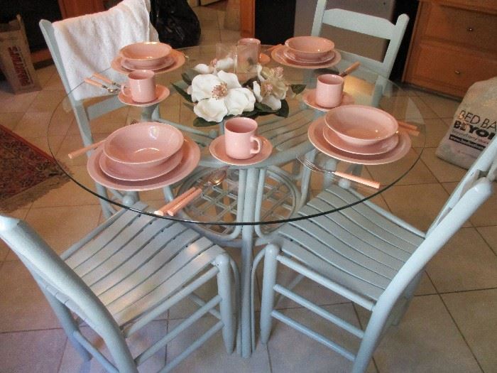 GLASS TOP TABLE W/ 4 CHAIRS AND A PINK SERVICE FOR 4 IN DINNERWARE