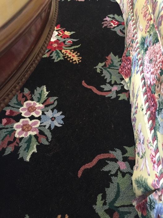 Closer view of wool black and floral area rug