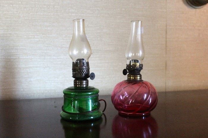 Miniature green or cranberry glass oil lamps. $125.00 each.