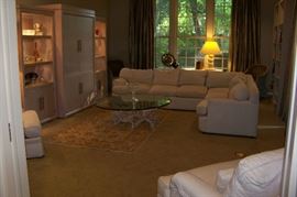 A view of the large den in the back of the house.  Beautiful sectional sofa and a great looking entertainment center with two side curio cabinets - both lighted.