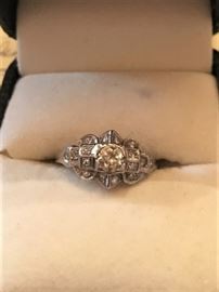 Antique platinum diamond ring.  European cut center diamond - .39 ct.  Sixteen single cut diamonds surround the center stone with an approximate weight of 16 ct.