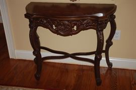 Ornate wood oval console table