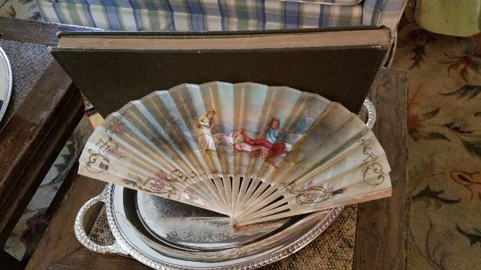 Antique fan on silver plate tray