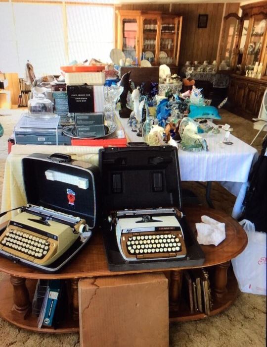 Large collection of Dolphin figurines, two vintage typewriters, vintage desks, antique library table