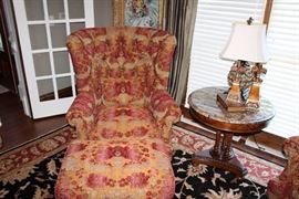 Highland House upholstered chair and ottoman, area rug, marble topped table, table lamp