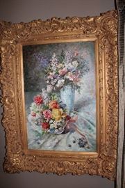 Oil painting in ornate gilt frame depicting a floral still-life