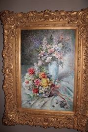 Oil painting in ornate gilt frame depicting a floral still-life