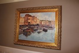 Oil painting in gilt frame depicting a harbor