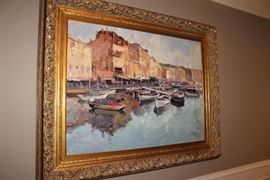 Oil painting in gilt frame depicting a harbor