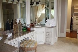 Master Bathroom: upholstered round bench, tri-fold mirror, towels