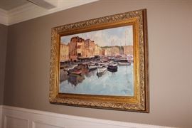 Oil painting in gilt frame depicting a harbor