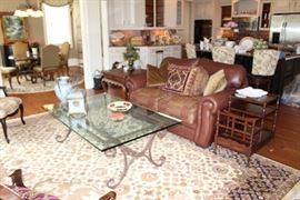 Sitting room off kitchen: Leather Mart love seat, area rug, glass & metal coffee table (3/4" thick glass!), Drexel Heritage canterbury table on metal casters