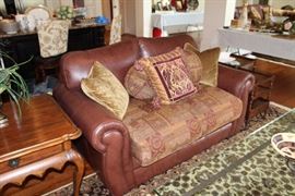 Leather Mart love seat, area rug