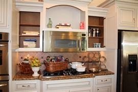 Assorted kitchenwares, woven baskets, casserole dishes, & metal wine rack. 