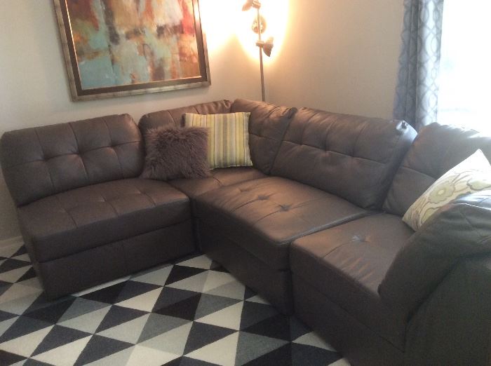 Like-new leather sectional, contemporary artwork, wool area rug