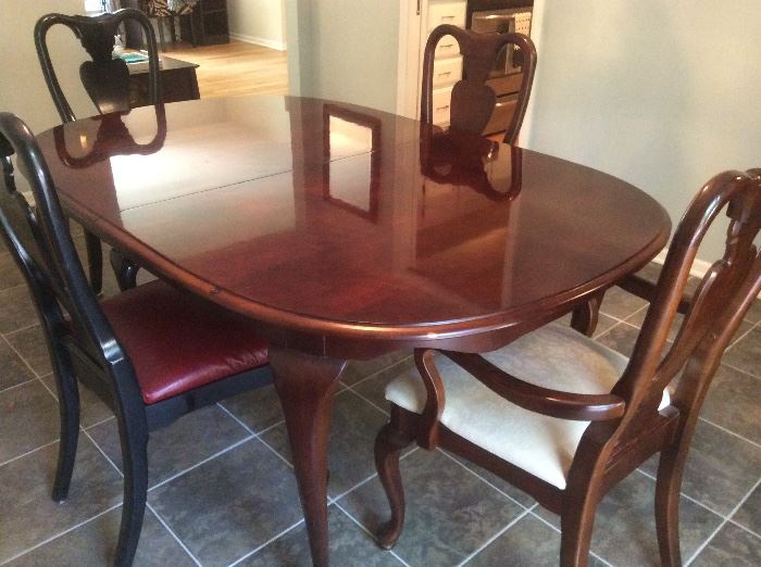 Cherry oval dining room table has two leaves