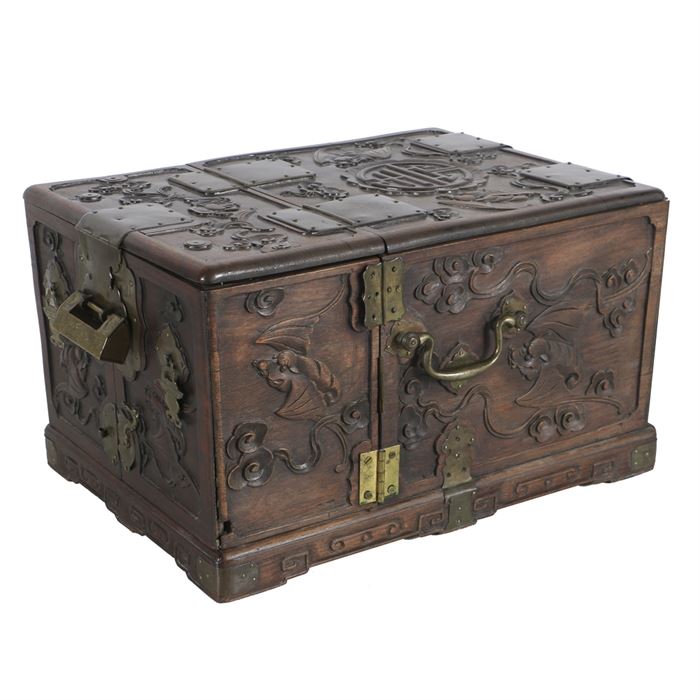 19th Century Chinese Carved Rosewood Vanity Box with Mirror: A 19th century Chinese carved rosewood vanity case, designed to be compact for travel with handles at each side. The outer box is carved with auspicious symbols and flying bats, then brass hardware and a geometric carved pattern at the base. The hinged top frames the mirror which props open revealing the four inner drawers and two storage boxes that swing outward. The original brass lock and key are present and working.