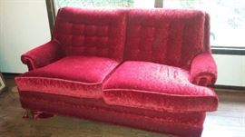 Pair of red velvet loveseats
