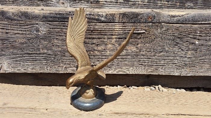 primitive, rustic decor includes brass and marble eagle