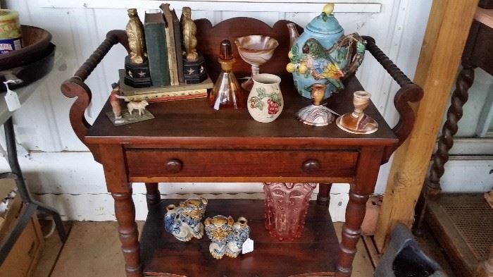 antique washstand, books, slag glass and other decor