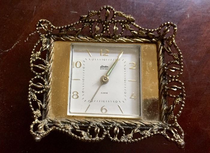 Small, delicate metal-framed vintage clock that perfectly accompanies vanity tray and jewelry box