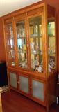 Breakfront w/ mirrored back, smoked glass bottom doors, touch hinge accent light.
$275