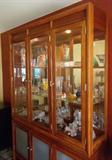 Breakfront w/ mirrored back, smoked glass bottom doors, touch hinge accent light.
$275