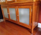 Breakfront w/ mirrored back, smoked glass bottom doors, touch hinge accent light.
$275