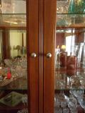 Breakfront w/ mirrored back, smoked glass bottom doors, touch hinge accent light.
$275