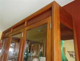 Breakfront w/ mirrored back, smoked glass bottom doors, touch hinge accent light.
$275