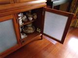 Breakfront w/ mirrored back, smoked glass bottom doors, touch hinge accent light.
$275