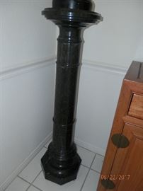 Solid Black marble column stand .  Some minor damage (chips)