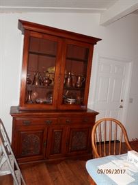 Large Antique breakfront / hutch.   Beautiful walnut and all lower cabinet doors are carved.    Full of copper decor.
