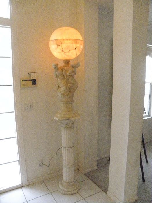 The total picture of the Greek solid marble sculpture lamp sitting on solid white marble fluted column....notice security system pad on the left