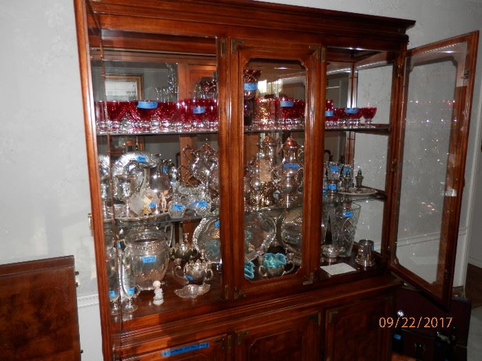 Hutch full of goodies including cranberry glass crystal.