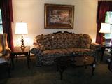 overstuffed style sofa with carved frame that has a matching lounge sofa, carved frame. paisley style fabric.