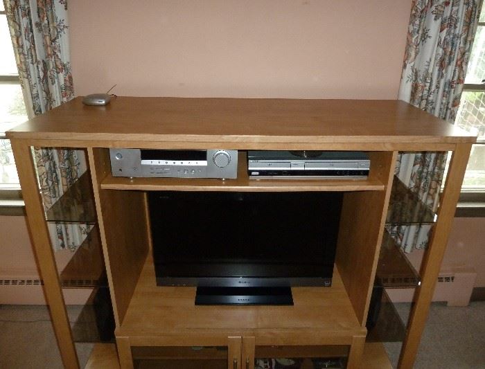 Modern entertainment, storage, display unit.  Solid wood, smoked glass shelves on each side, large opening for flat screen TV, double door storage area, shelf for components ... nice!